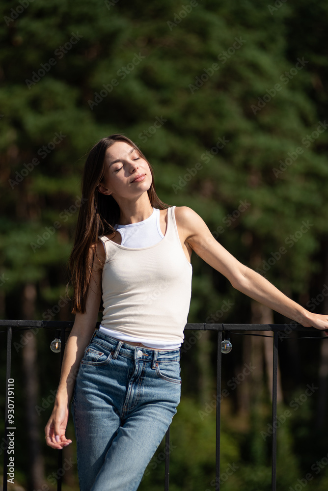 young woman in blue jeans and t - shirt standing by pool in summer day, portrait young woman in blue jeans and t - shirt standing by pool in summer day, portrait