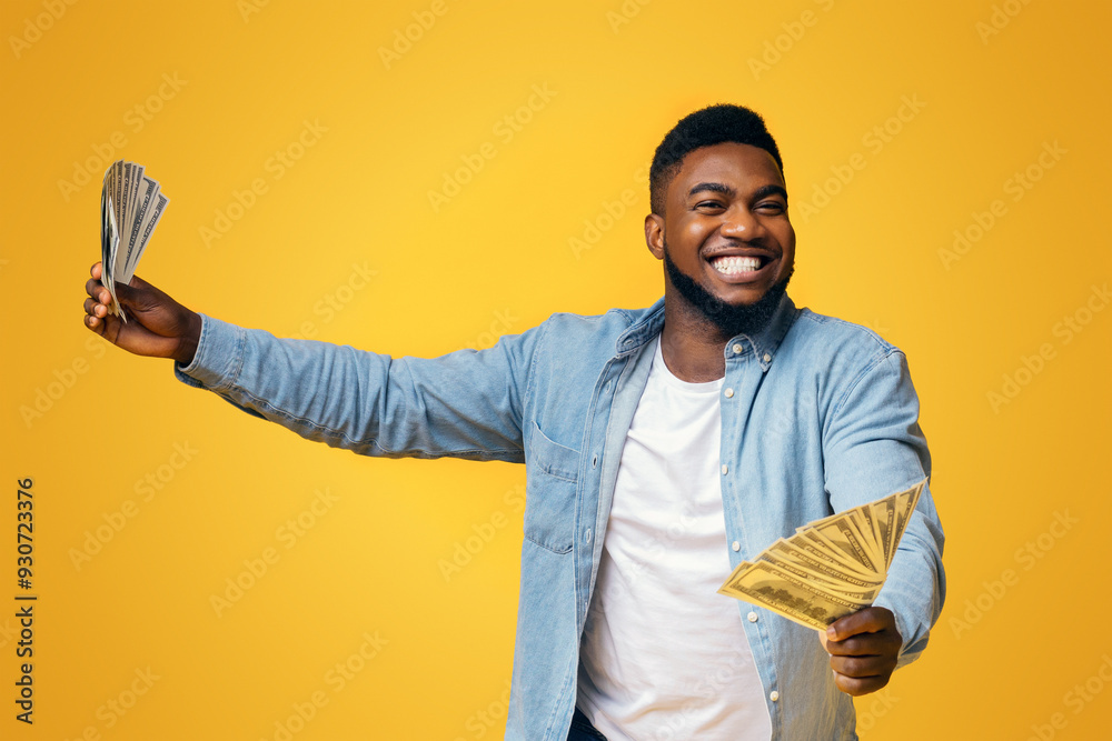 © Prostock-studio - Big Win. Overjoyed African American Man Holding A Lot Of Money In Both Hands On Yellow Background, Panorama © Prostock-studio - Big Win. Overjoyed African American Man Holding A Lot Of Money In Both Hands On Yellow Background, Panorama