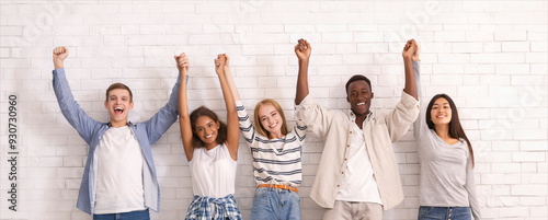 Photography Joyful international group of teenagers raising joined hands up together over wh