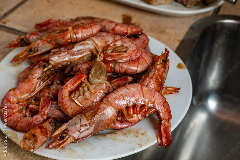 Delicious dish of grilled prawns separated from a large paella Delicious dish of grilled prawns separated from a large paella