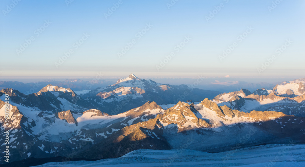 Fototapeta premium mountain peaks in morning dawn light, panoramic natural landscape