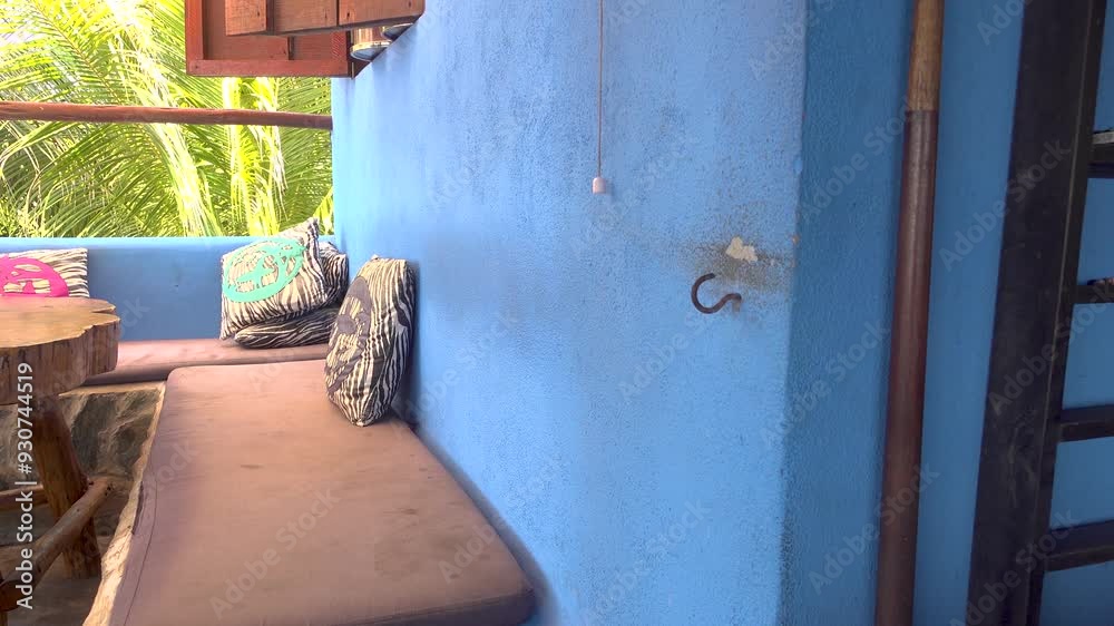 Someone plays the hook and ring game indoors on a sunny day (Bimini Ring, or Ring the Bull)