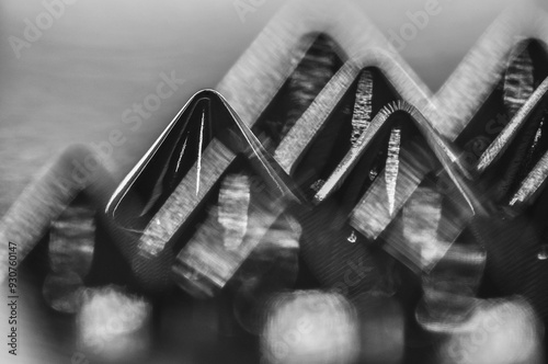 Close-up macro of sewing studs arranged in symmetrical rows in black and white abstraction abstract