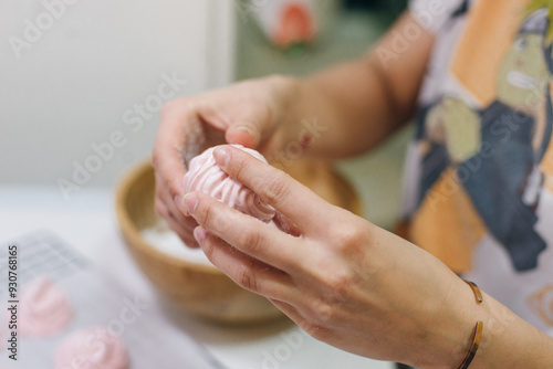 Homemade pink marshmallows on baking paper background on the kitchen