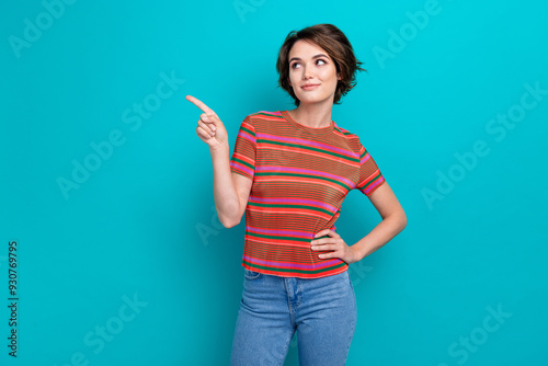 Photo of cute woman with bob hairstyle dressed striped t-shirt indicating look at empty space offer isolated on turquoise color background