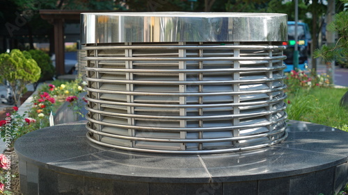 Photography Cylinder-shaped metal ventilation facility in front of a shopping center in Seou