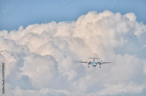 Turbo Prop airplane flying in fluffy clouds