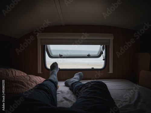 Obraz na płótnie Morning views to the beach through the motor home window lying on bed pov