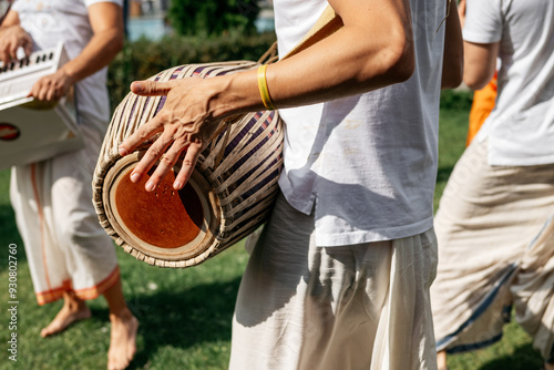 A man plays traditional Indian drums at a street festival. Close-up, no face. photo