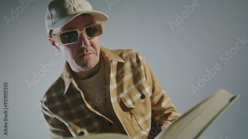 Rap artist reading from a textbook on a warm background