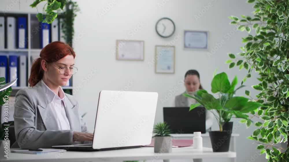 custom made wallpaper toronto digitalworking day, young woman working on computer and writing in notebook sitting in office together with her female colleague