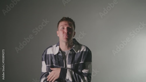 Rap artist singing for a music video on a textured light background