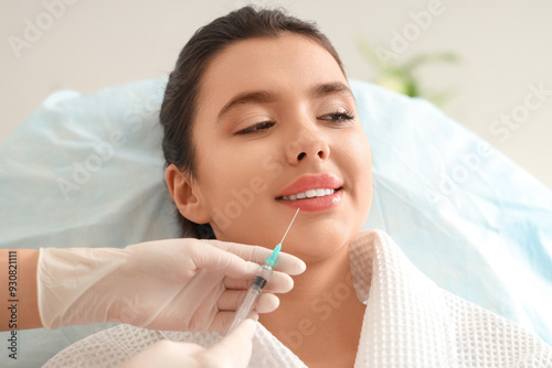 Young woman receiving lip i...