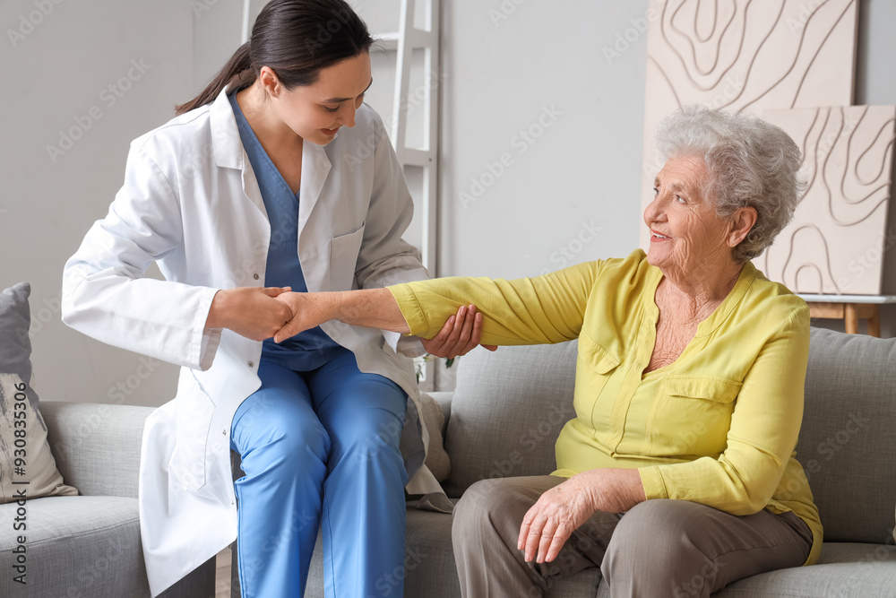 Physical therapist helping senior woman at home Physical therapist helping senior woman at home