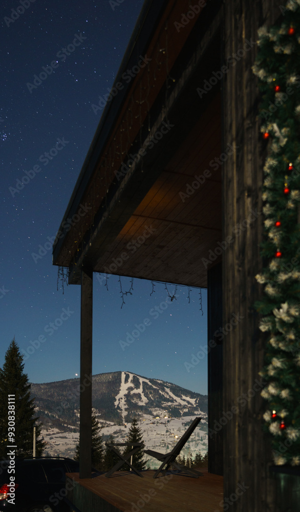 Wooden chair on house patio with snowy mountain view Wooden chair on house patio with snowy mountain view