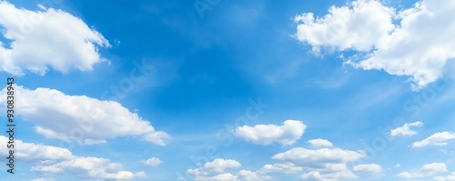 Panoramic banner of a blue sky with clouds and ample copy space, ideal for backgrounds and design use.