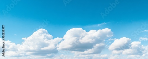 Panoramic banner of a blue sky with clouds and ample copy space, ideal for backgrounds and design use.