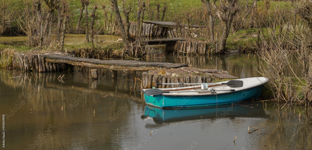 An old boat in a lake with old bridges in creepy forest An old boat in a lake with old bridges in creepy forest