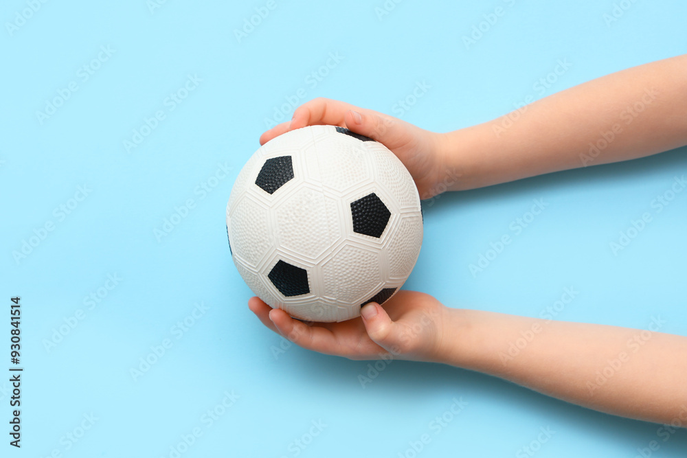 Child's hands with soccer ball on color ball, closeup Child's hands with soccer ball on color ball, closeup