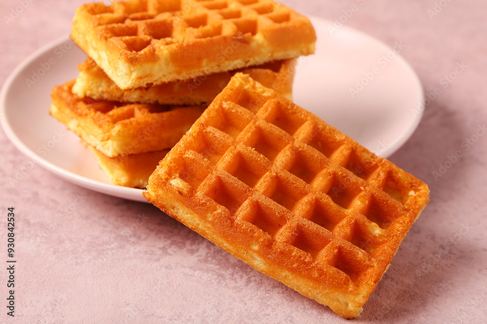 Plate with tasty Belgian waffles on pink background Plate with tasty Belgian waffles on pink background