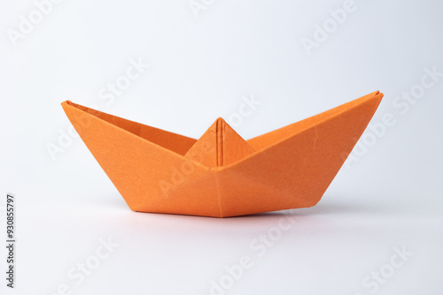 orange paper ship on white background ,concept for leadership, teamwork and winning success.