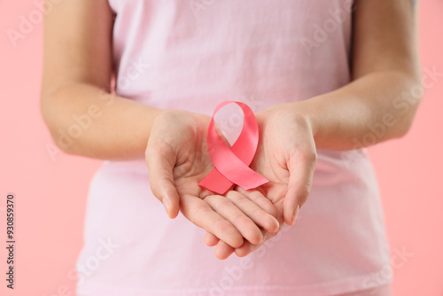 Young woman with pink ribbo...