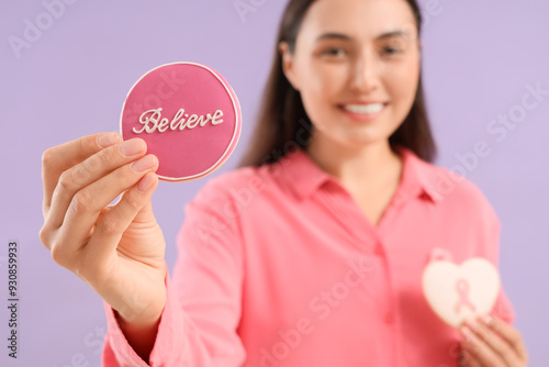 Young woman with cookies on...