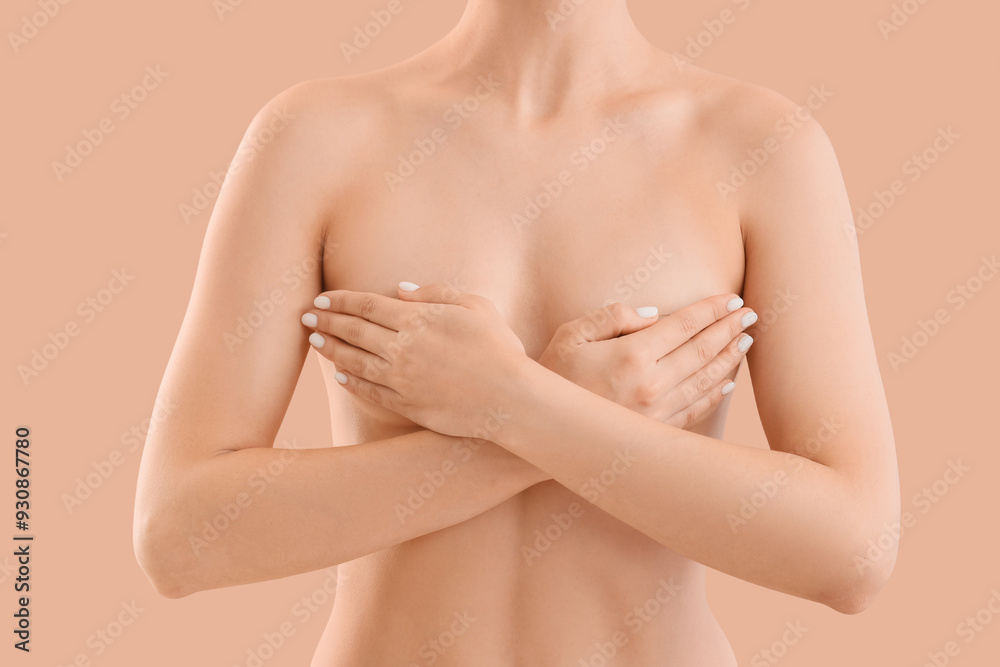 Naked woman on beige background, closeup. Breast cancer awareness concept Naked woman on beige background, closeup. Breast cancer awareness concept