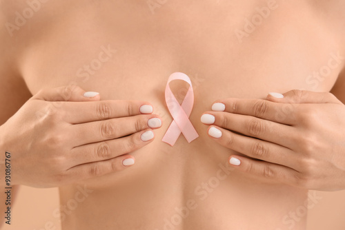 Naked woman with pink ribbo...