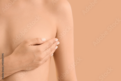 Naked woman on beige backgr...