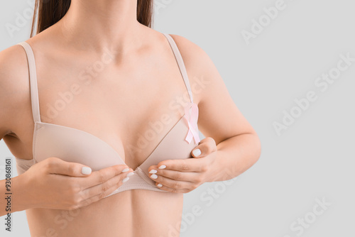 Young woman in bra with pin...
