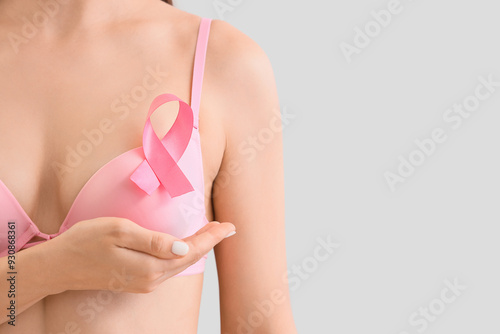 Woman in bra with pink ribb...