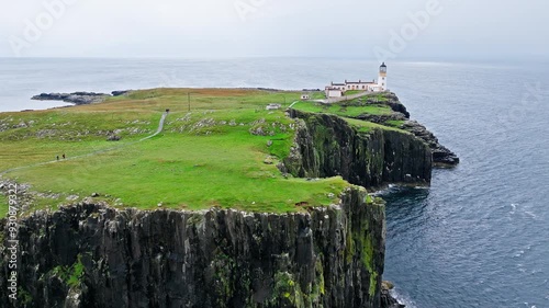 Dramatic rocky cliff on the coastline in Scotland, United Kingdom. Scottish Highlands.Travel destination. Tourist attraction landmark Neist Point Lighthouse on Isle of Skye.