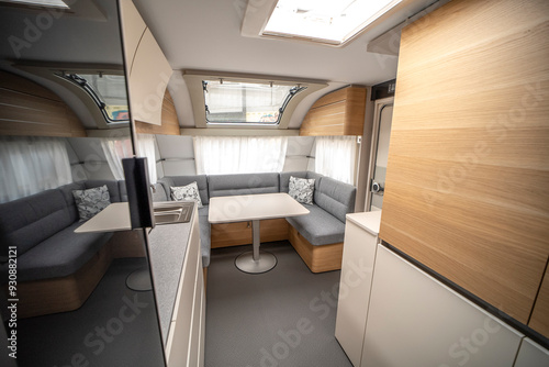 Interior with,tables,refrigerator,kitchen corners,ceiling ligthning,couches,living space in modern Slovenian camper van Adria.