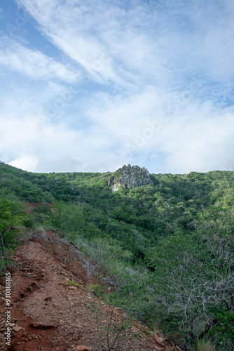 Road to the mountain. Arid mountains. Paths through the mountains with cacti and xeric vegetation. Red earth. photo