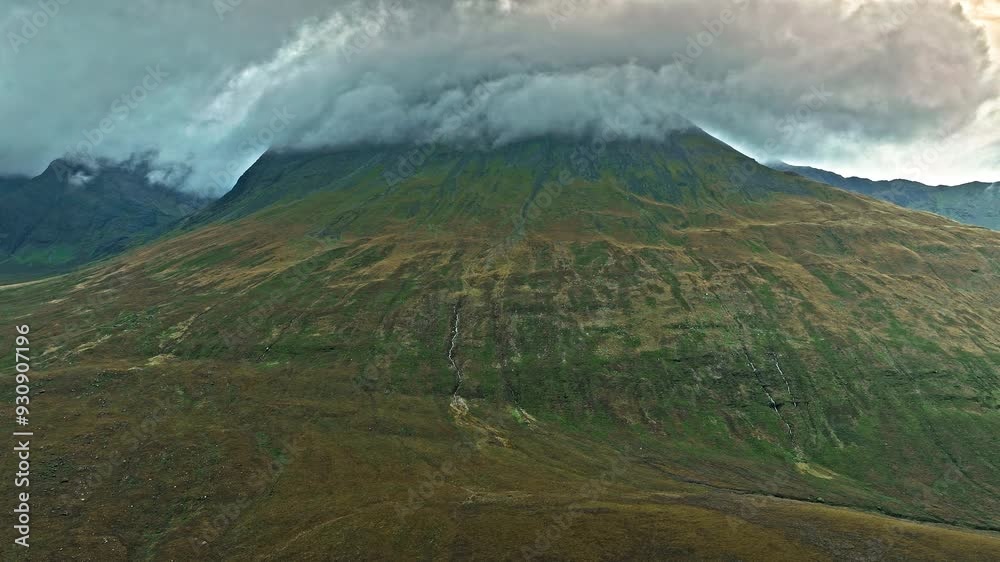Scenic view of sunset over a high mountain in the Isle of Skye. Scottish Mountain peak, geological formation on the Highlands of Scotland, United Kingdom. Scenic view of sunset over a high mountain in the Isle of Skye. Scottish Mountain peak, geological formation on the Highlands of Scotland, United Kingdom.