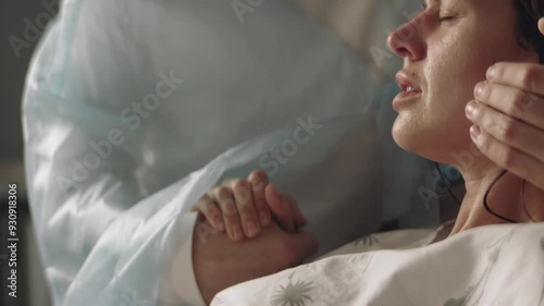 Midwife at the hospital during childbirth helping the woman