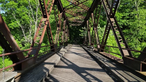 Springtown Railway Bridge over River in Springtown, New York Wallkill Valley Rail Trail (Paltz trestle viaduct) aerial drone view steel beams bars wooden platform from above trees scenic bike trail photo