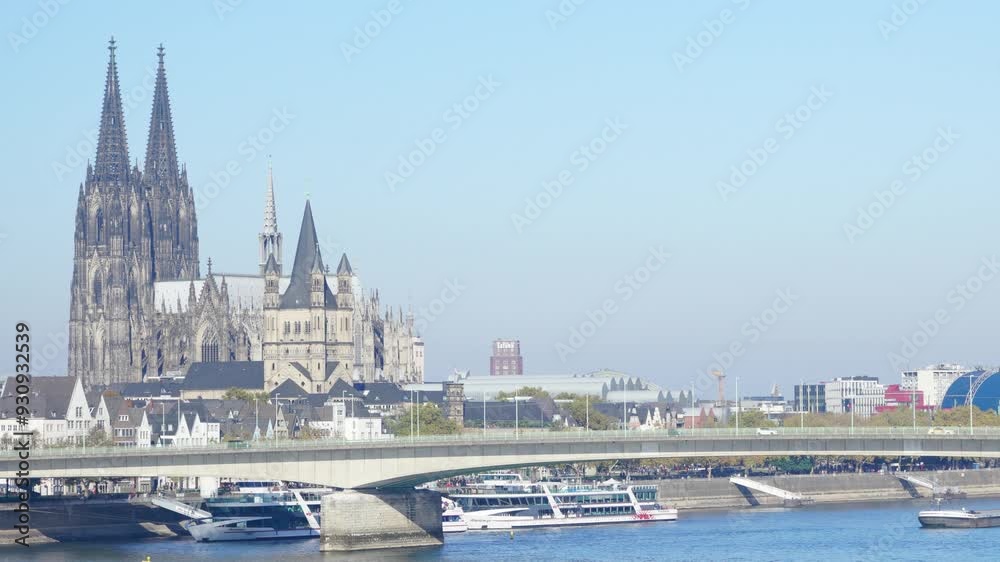 A bridge spans a river with a cathedral in the background. The bridge is a metal structure with a green color A bridge spans a river with a cathedral in the background. The bridge is a metal structure with a green color