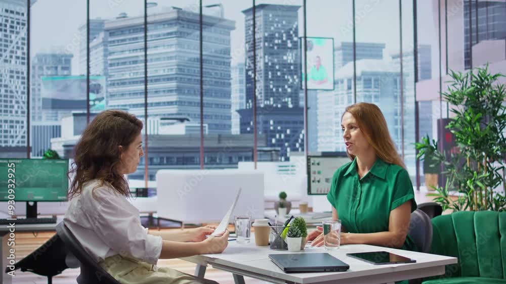 Human resources manager conducts interview with job seeker in modern office, discussing long term career goals and qualifications for the vacant position within the company. Recruitment. Camera B. Human resources manager conducts interview with job seeker in modern office, discussing long term career goals and qualifications for the vacant position within the company. Recruitment. Camera B.