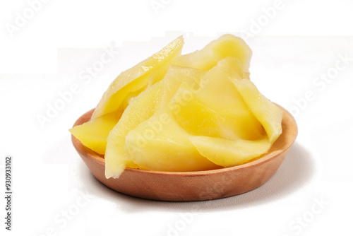 Young mango kickshaw, made from thinly sliced tangy yellow mango, placed on a wooden dish, photographed with a white background. photo