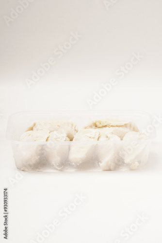 Frozen stuffed Cireng, a traditional Indonesian snack ready to fry, filled with seasoned beef fat or koyor, photographed against a white background. photo