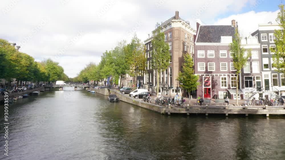 A row of boats are docked in a canal. The boats are of various sizes and colors, and they are all lined up along the water. The scene is peaceful and serene A row of boats are docked in a canal. The boats are of various sizes and colors, and they are all lined up along the water. The scene is peaceful and serene