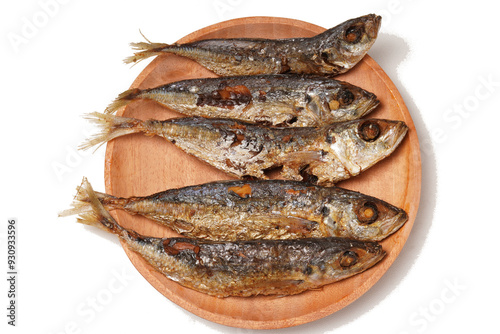 Fried Gereh Keranjang (pindang keranjang) fish, a traditional Indonesian side dish, served on a wooden plate and photographed with a white background. photo