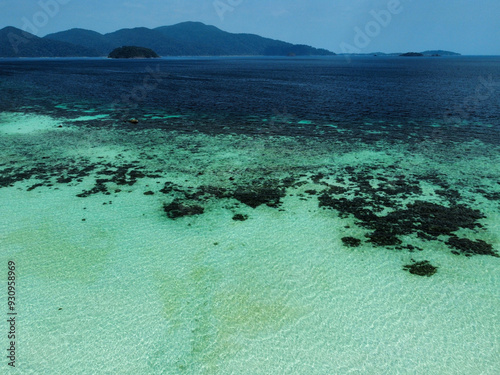 Aerial view of paradise beach with turquoise water and coral reef; drone picture from Koh Ra Wi with Koh Lipe in the background; Thailand photo