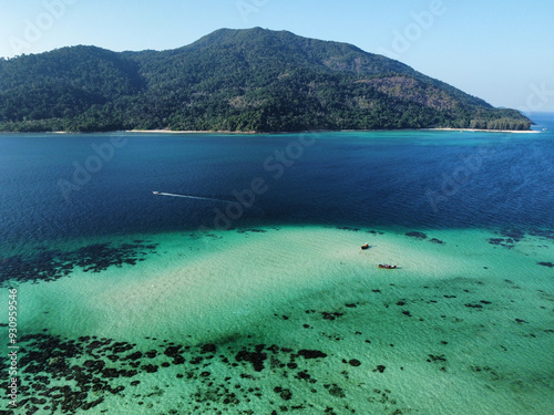 Majestic view of Ko Adang from Koh Lipe that shows the mountains of the island, the vegetation, the blue ocean, turquoise water with coral and white photo