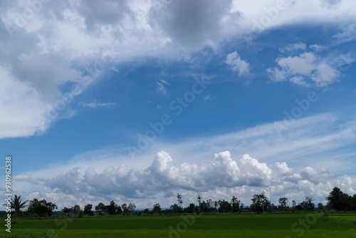 Rice field showing dramatic weather conditions and cloud formations during tropical rainy season. photo