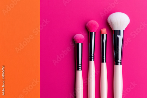 Set of cosmetic brushes on a pink and orange background