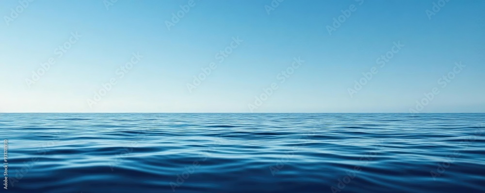 Fototapeta premium A serene view of the calm ocean under a clear blue sky, perfect for conveying tranquility and peacefulness.