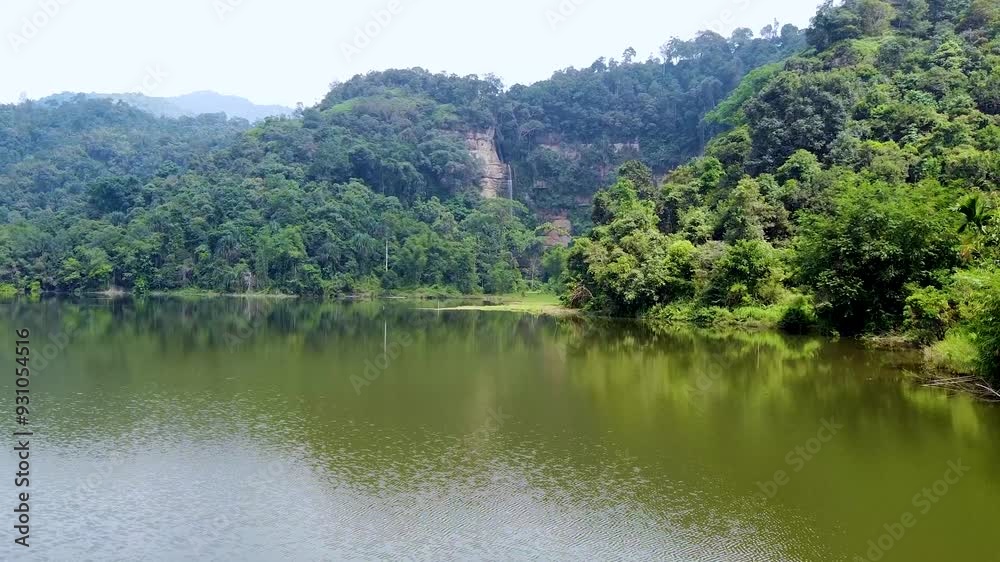 video of waterfall and forest in front of the lake video of waterfall and forest in front of the lake